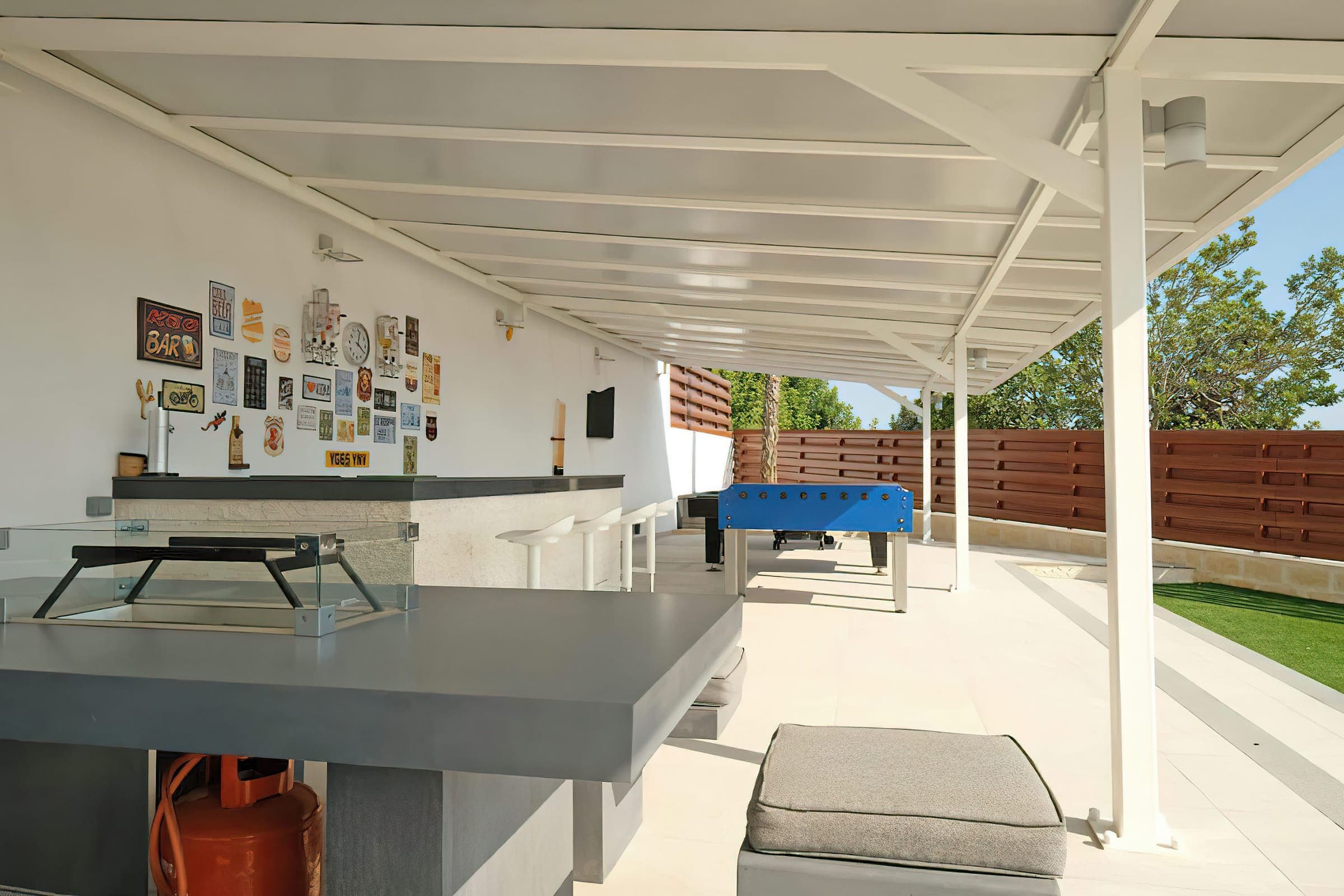 Covered outdoor bar and games area with table tennis and table football