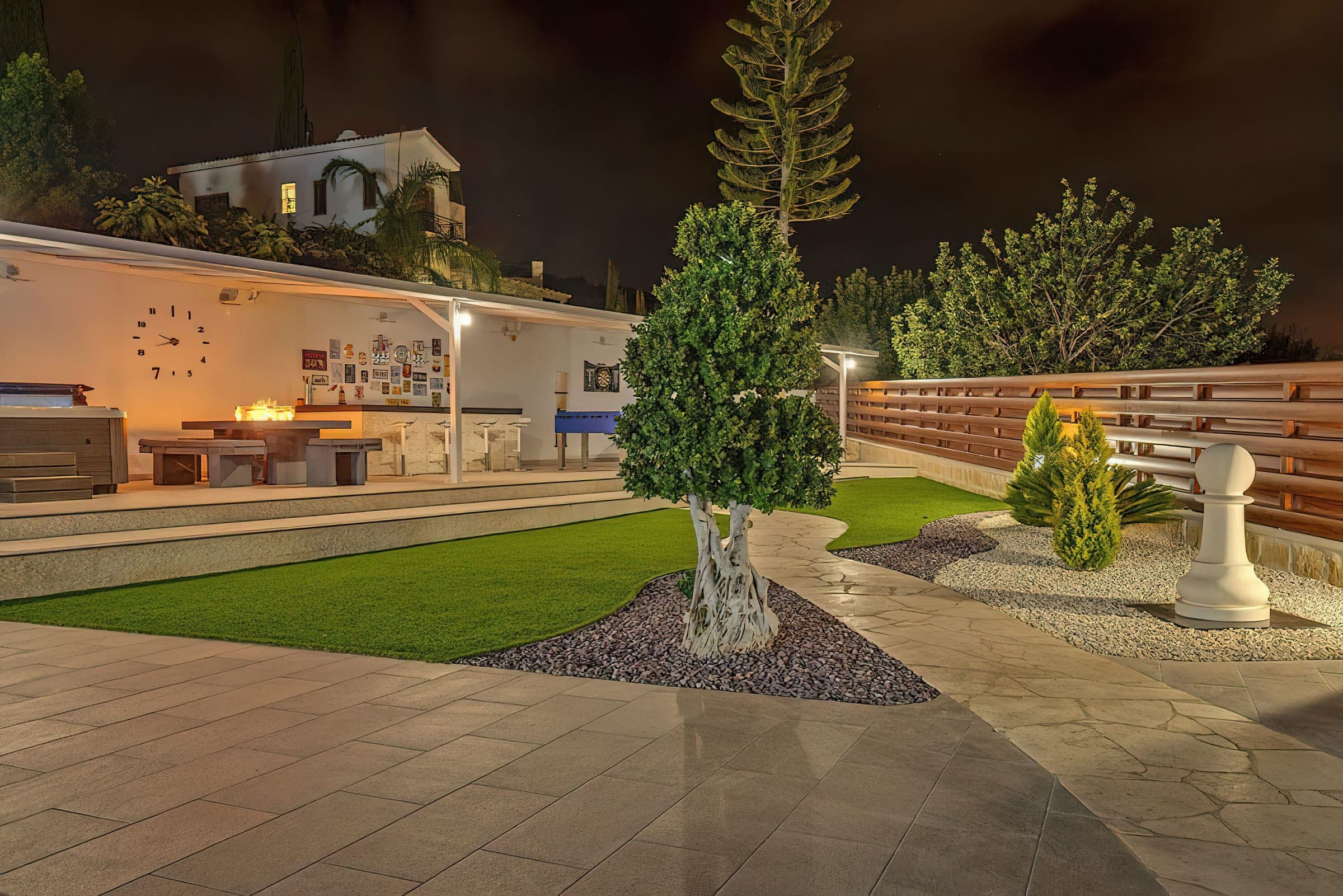 Outdoor bar and fire pit area glowing at night
