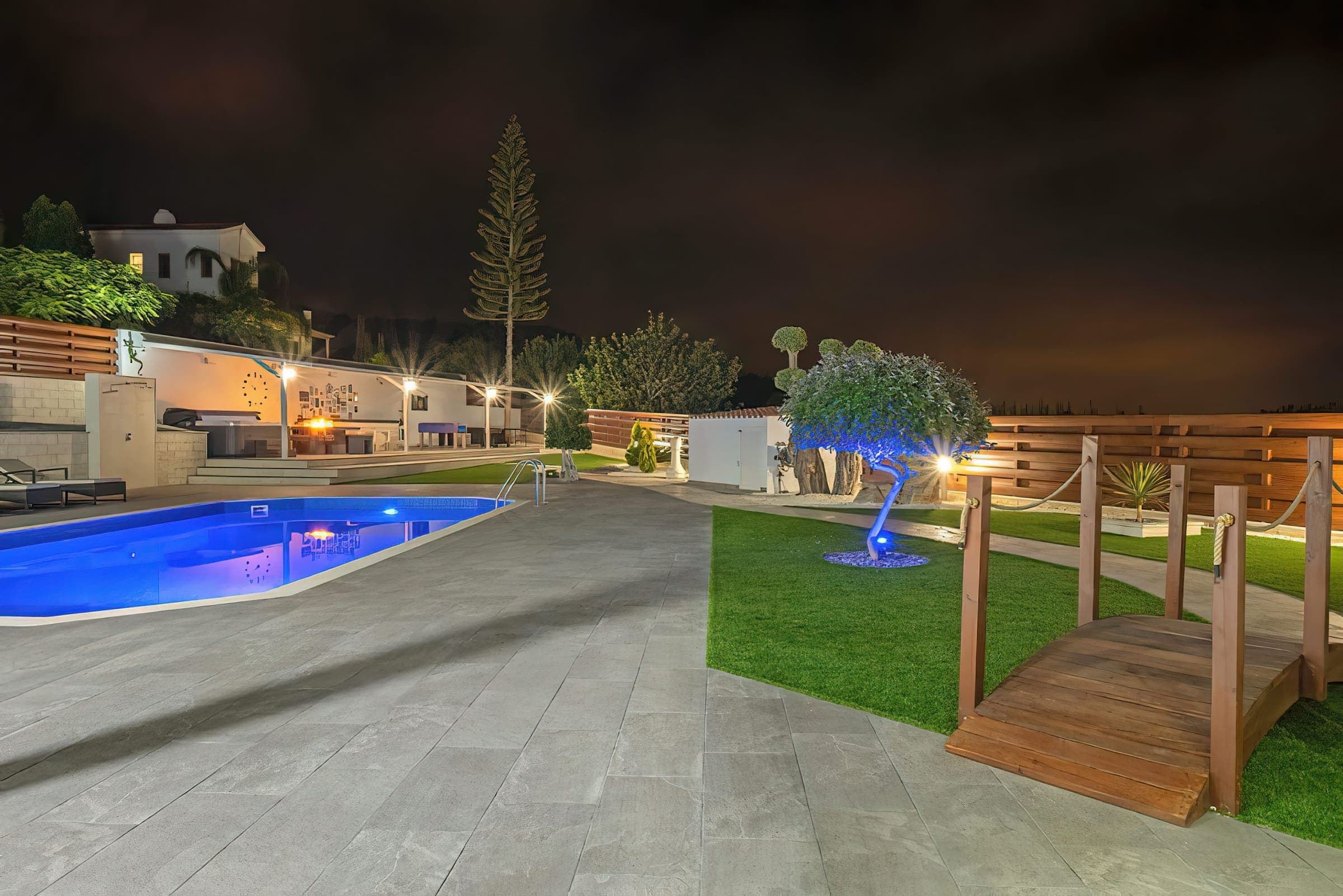 The pool and garden lit up at night