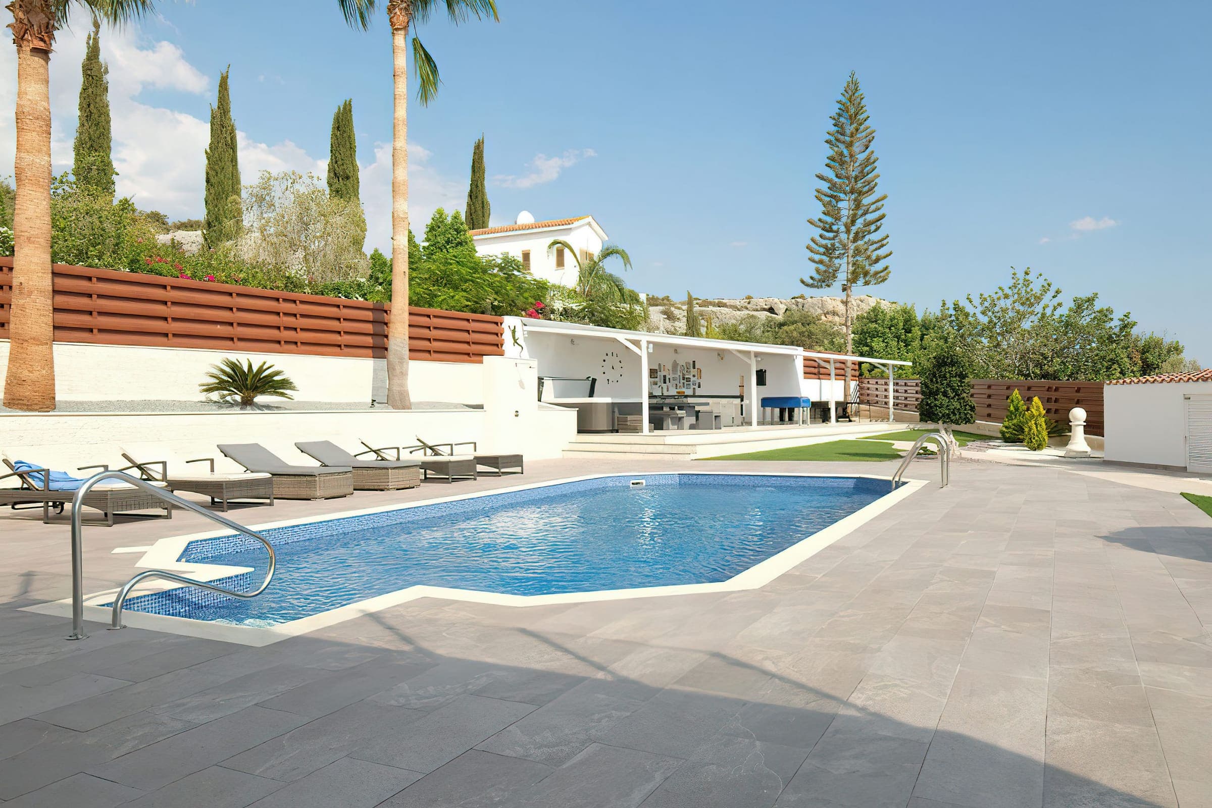 6 × 12 m private pool lined with sun loungers and palm trees
