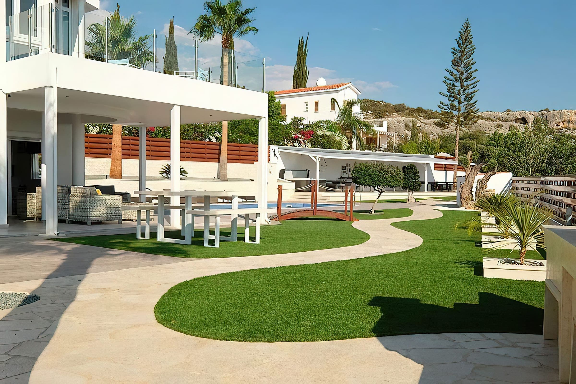 Covered terrace with outdoor dining overlooking the garden