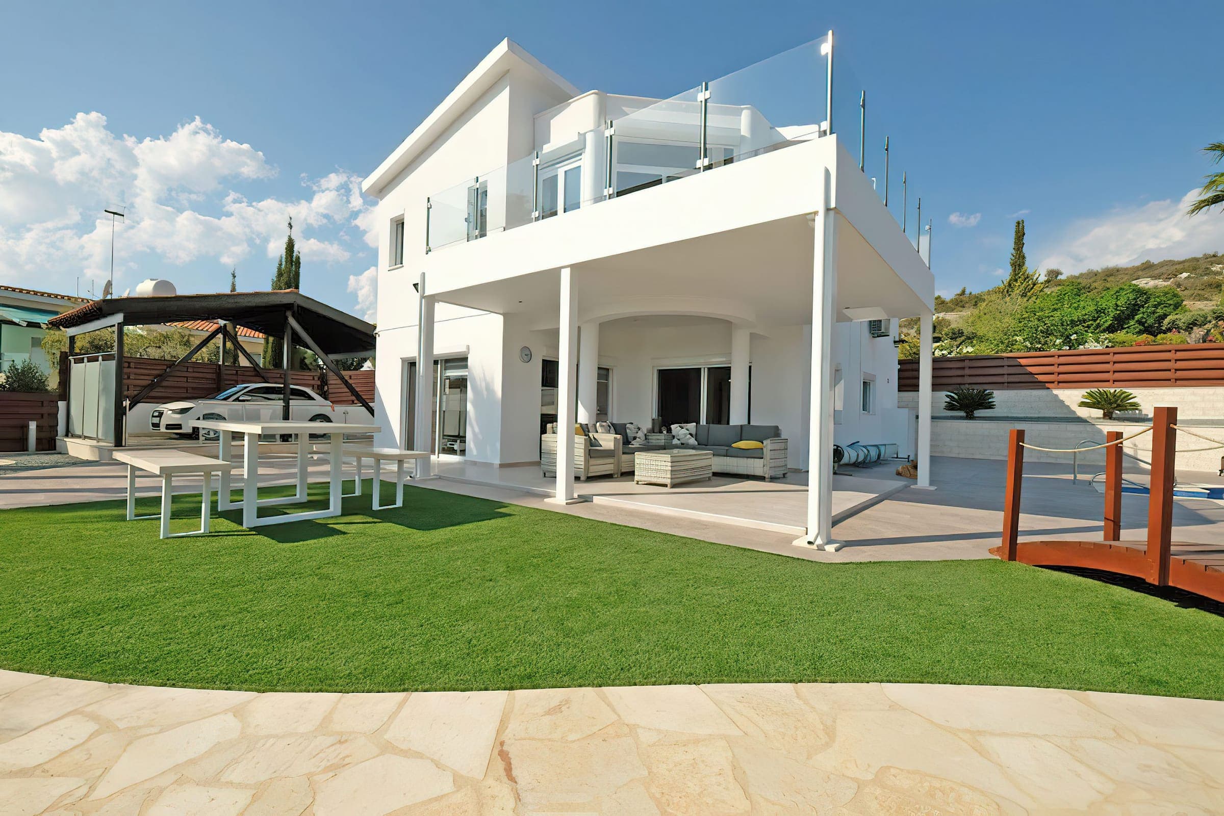 Rear of the villa with covered terrace and outdoor dining table